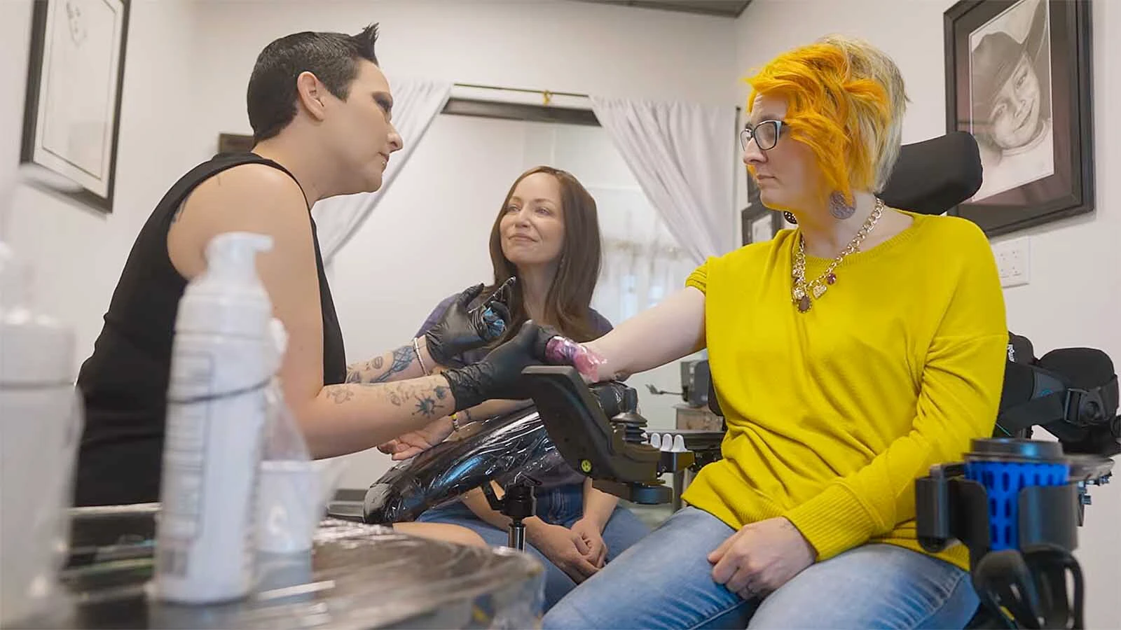 Nelly Brown, left, gives Deanna Cotten a “joy” tattoo as part of a documentary about having joy while being diagnosed with a terminal illness.