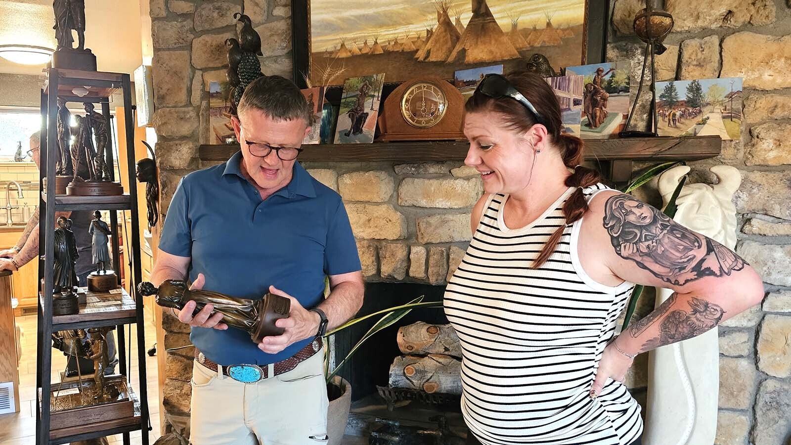 Harvey Deselms talks about the Cheyenne Capitol Avenue Bronze Project with a guest at his home during a party to unveil some of the new statues that will be installed this week. The project has so far installed 82 statues. Another nine are underway, leaving just nine more to go to get to 100.