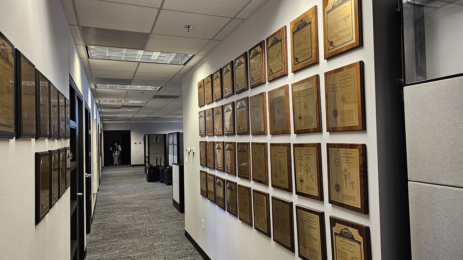 The Wall of Innovation wraps around one wall into this hallway. This is not even all of the patents. Some have yet to be hung, as the clinic has started to run out of room to display all of its patents.