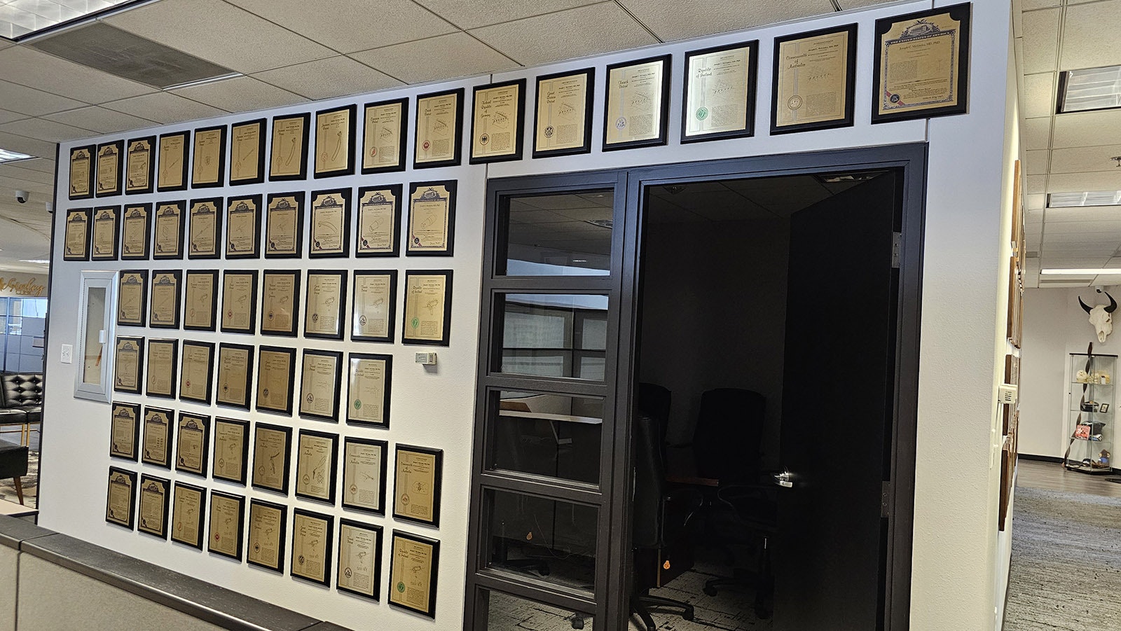 The wall of innovation at The McGinley Clinic, which has more than 135 patents from around the world for various, cutting edge medical devices.