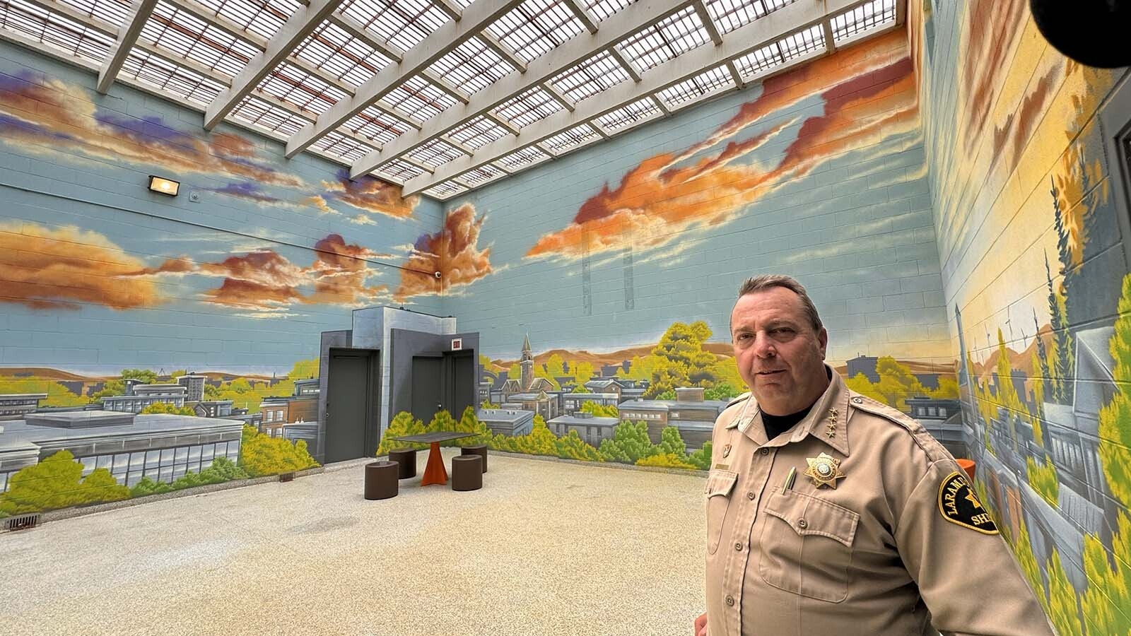 Laramie County Sheriff Brian Kozak talks about the new mental health pods at the Laramie County Detention Center, describing how a significant number of inmates have serious mental problems but the jail didn't have an adequate place to hold them. Outside the common area is a common outdoors plaza where inmates can get some sun for an hour.