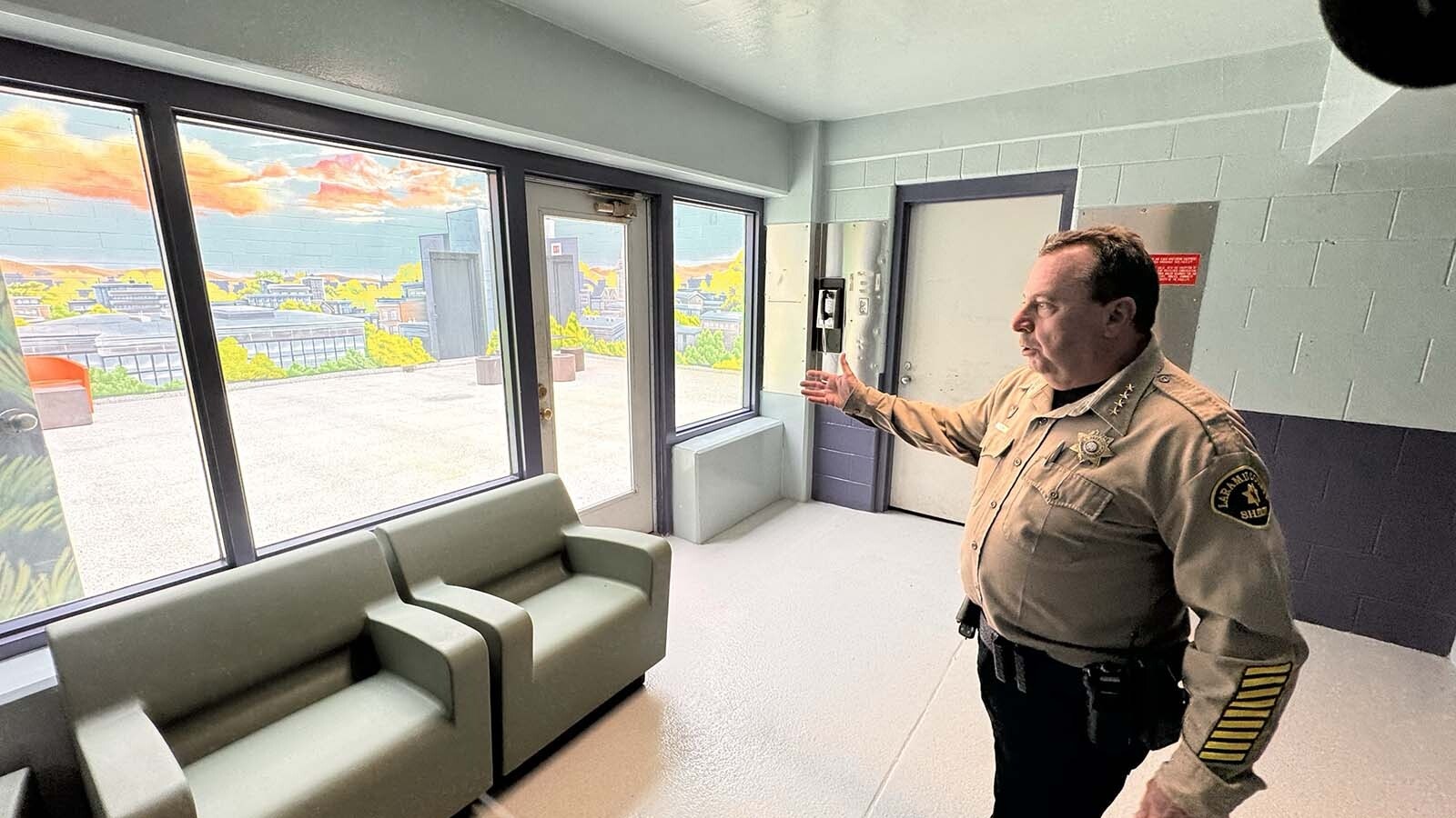 Laramie County Sheriff Brian Kozak talks about the new mental health pods at the Laramie County Detention Center, describing how a significant number of inmates have serious mental problems but the jail didn't have an adequate place to hold them. Outside the common area is a common outdoors plaza where inmates can get some sun for an hour.
