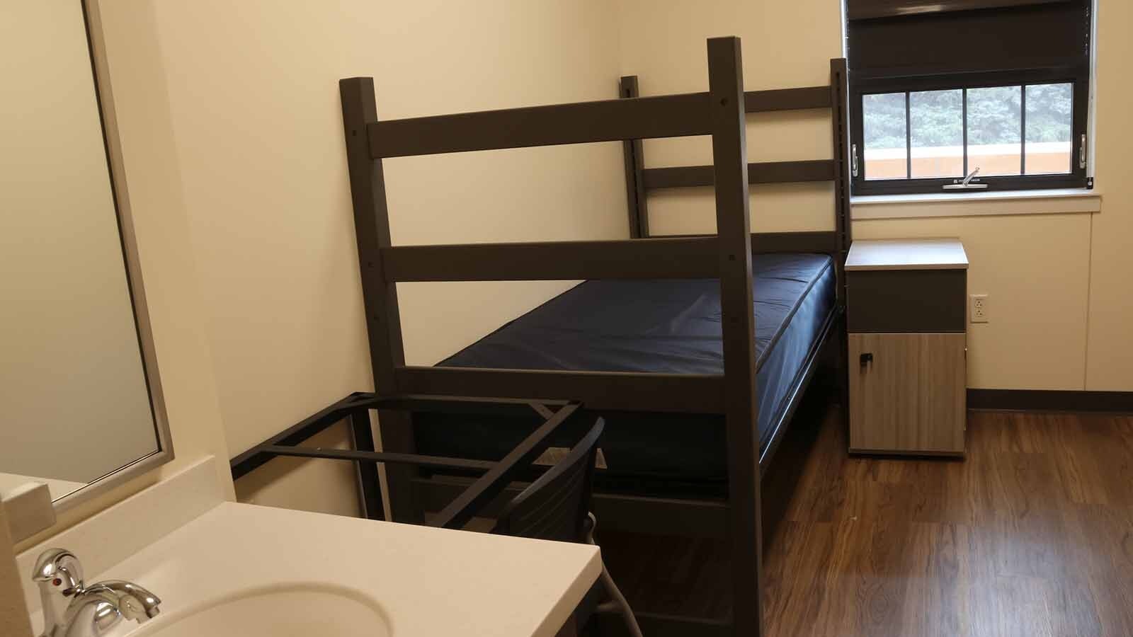 A single dorm room in the North Hall awaiting its first resident. Windows are connected to the HVAC system so it a window opens, air conditioning or heating shuts off.