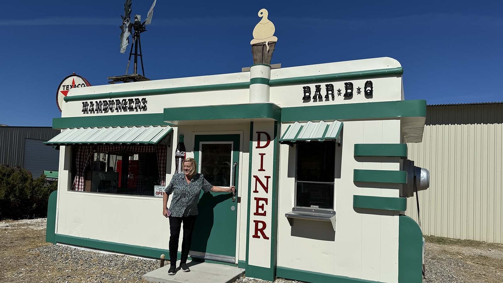 Park County archivist Robyn Cutter prepares to enter the restored Nifty Niner diner. Cutter researched the diner's journey from a street corner in Cody to various spots in Meeteetse, Greybull, and Otto before it was brought back to Cody.