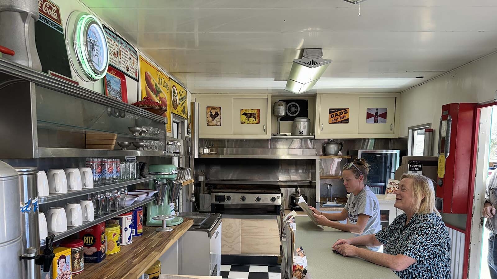 Robyn Cutter takes in the 1950s ambiance inside the Valentine diner restored by Ken Quintiliani. The stainless steel structure was being used as a chicken coop when Quintiliani bought it, and he's spent two years restoring and improving it.