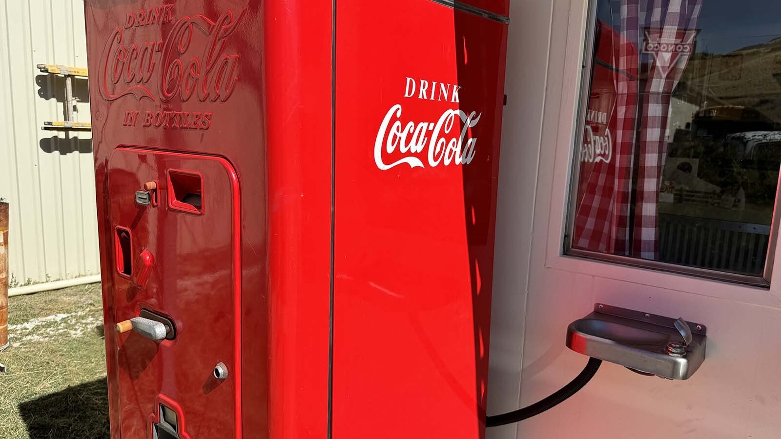 A vintage outdoor Coca-Cola machine with an attached Coca-Cola-manufactured water fountain. The fountain is non-functional, but Ken Quintiliani attached it to his restored Valentine diner as a historical relic from a time when several states required water fountains be placed next to Coke machines.