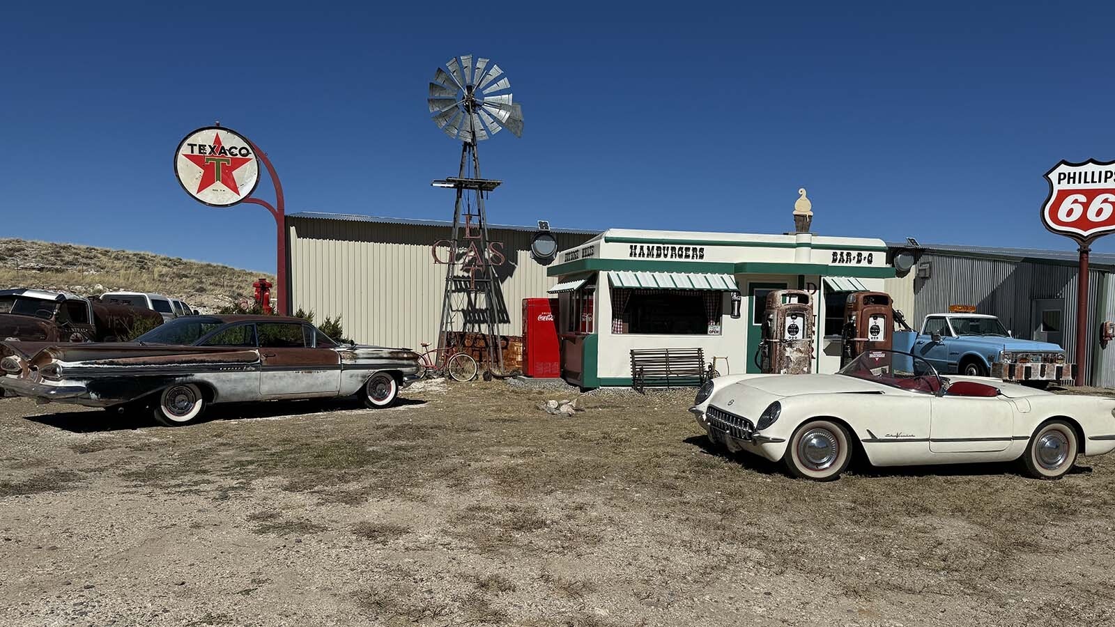 A 1959 Chevy Impala and a 1954 Corvette parked in front of the restored Nifty Niner diner.