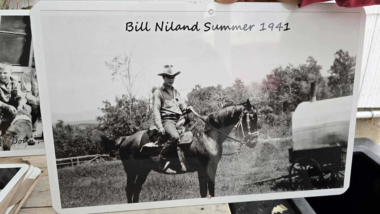 Photo reproduction of Bill Nilsand on a horse in the summer of 1941 at the Niland Cabin in the Medcine Bow-Routt National Forest.