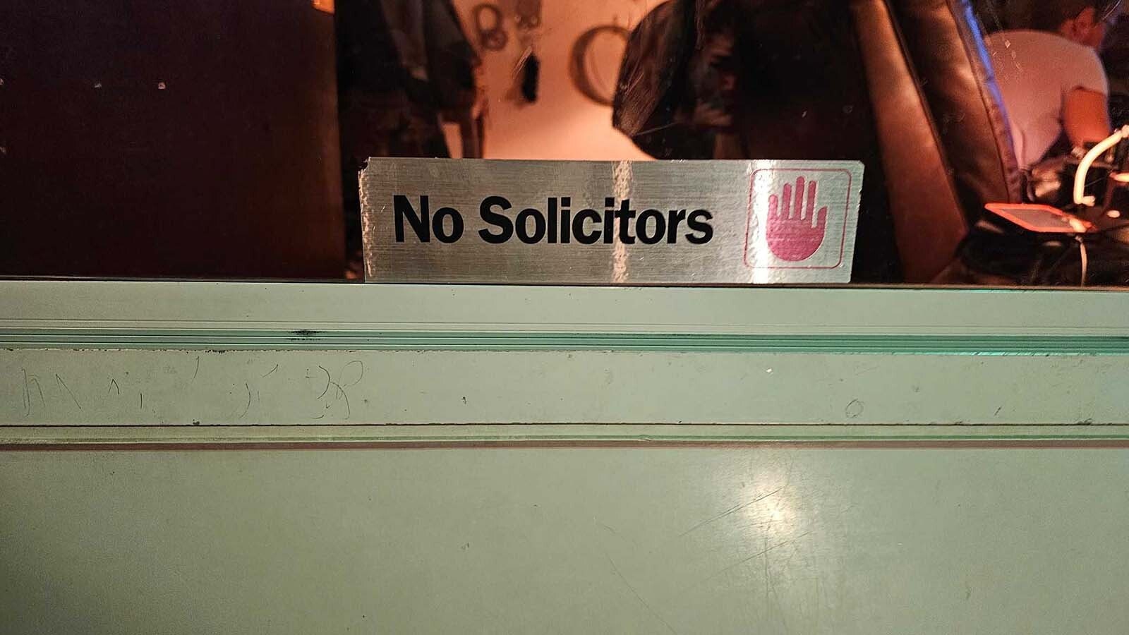 There are multiple signs displayed at this home to fend off solicitors. Even so, they still sometimes come knocking.