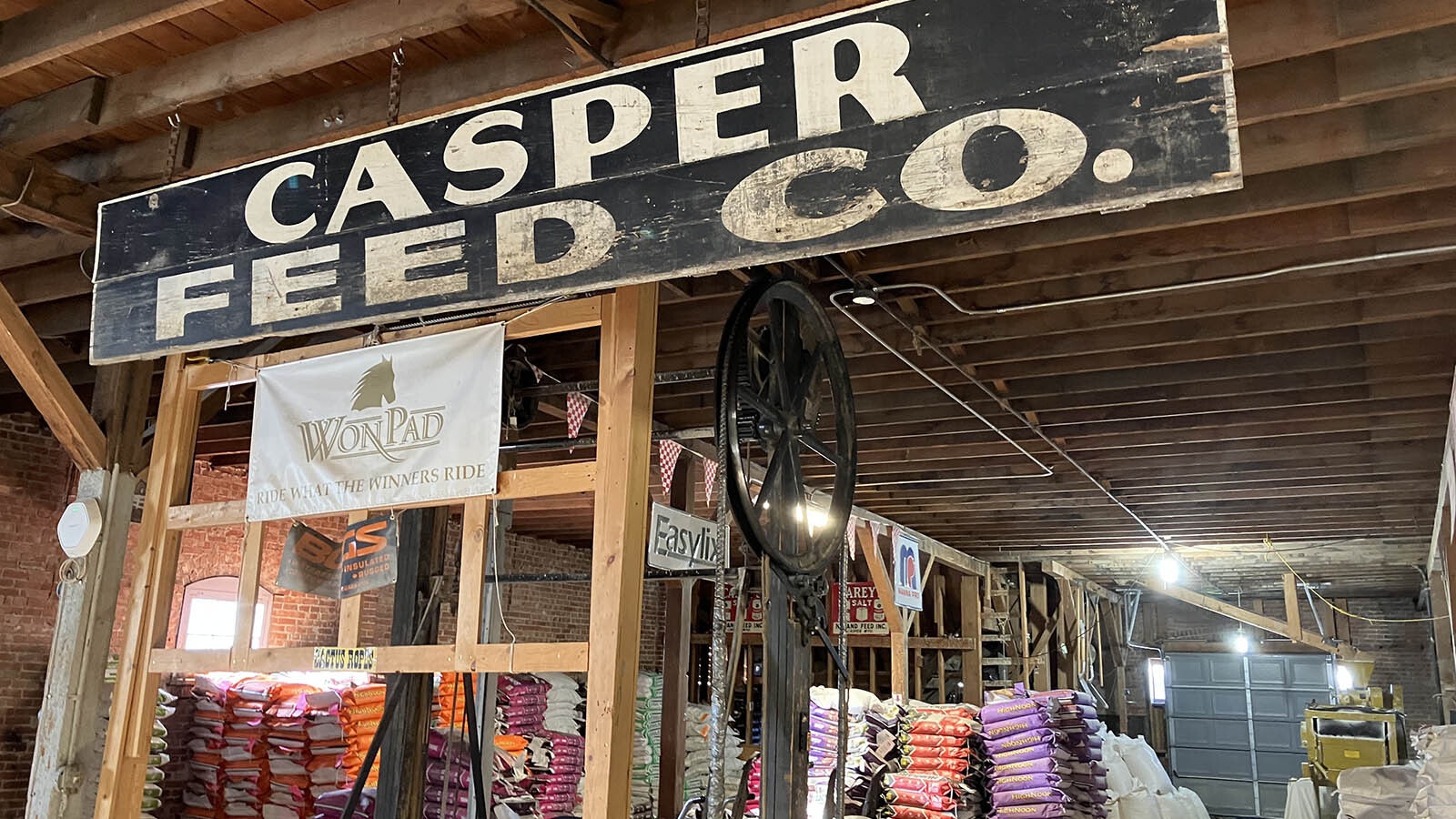 The original Casper Feeds sign hangs in the warehouse.