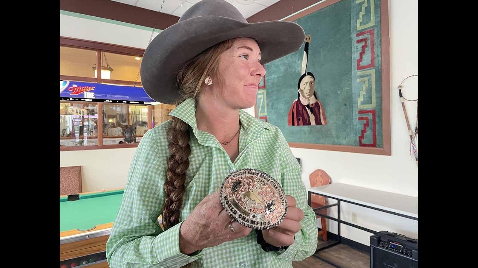 Tup Forge can’t believe she got the gold buckle at the Cheyenne Frontier Days Rodeo.