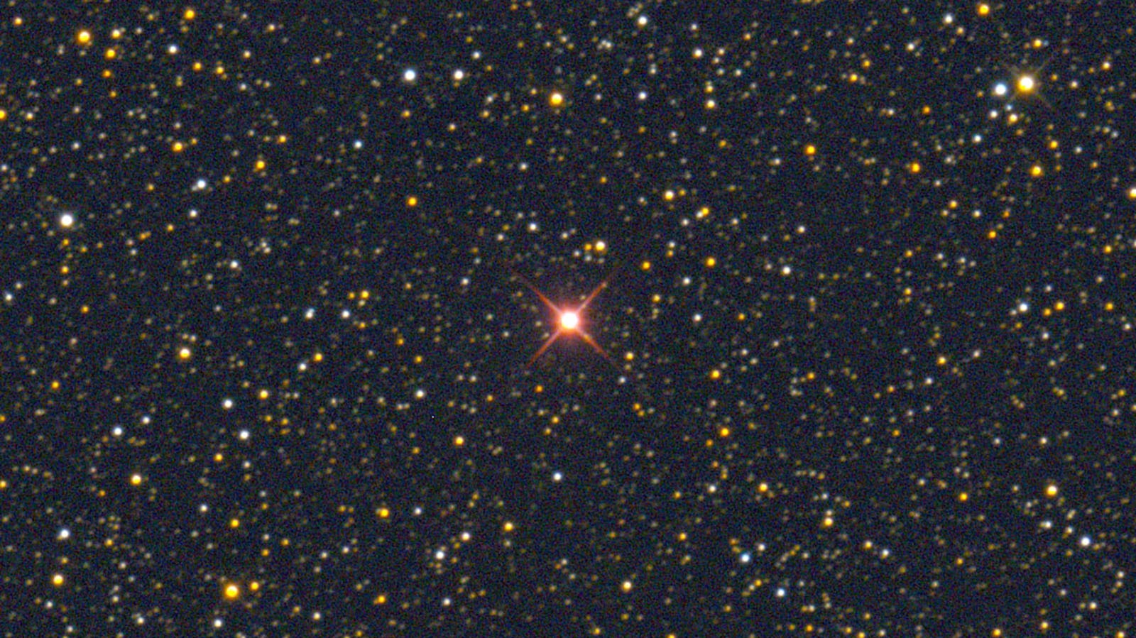 A nova in Hercules glows red during its early explosive phase.