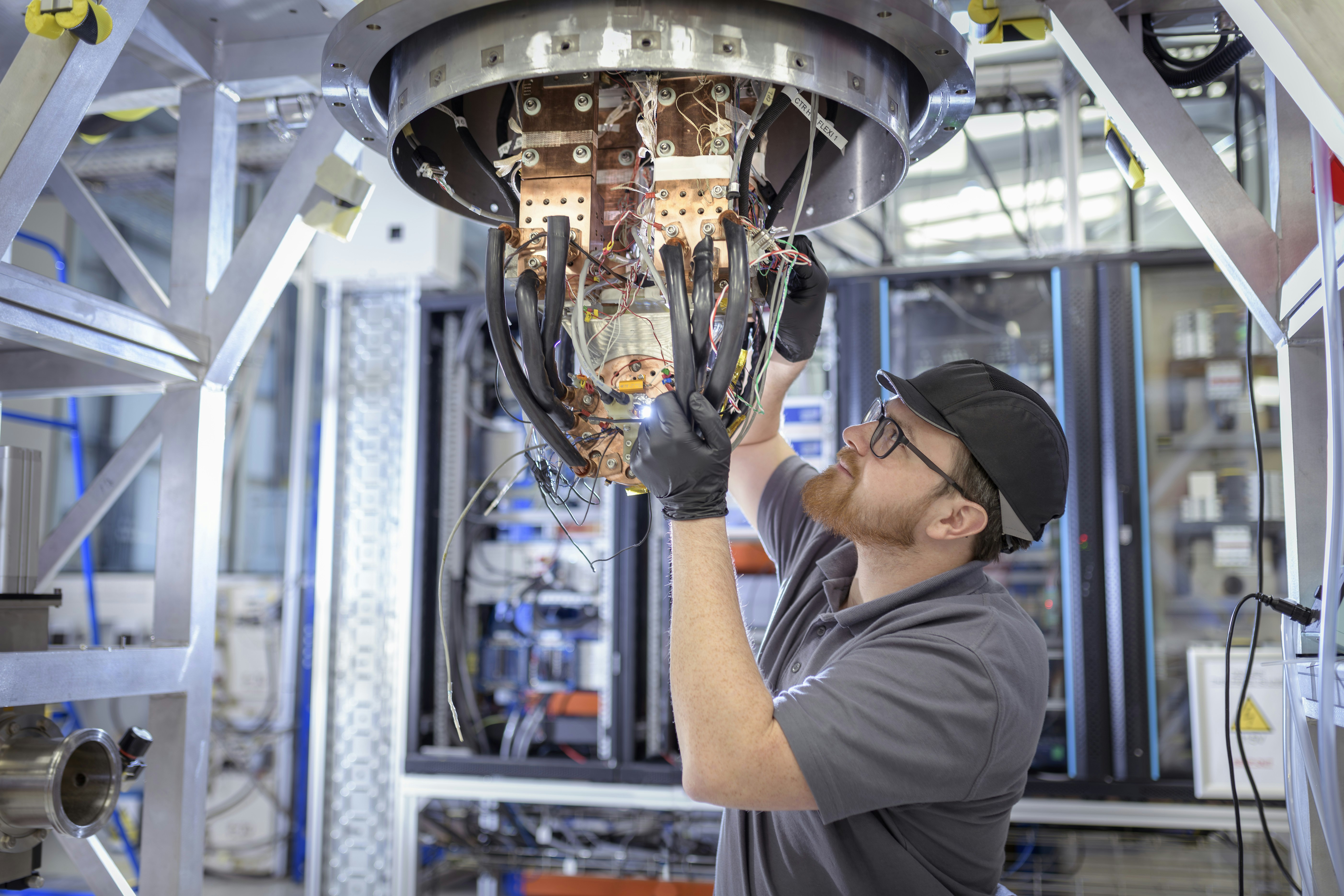 A technician assembles a superconducting magnet used in a nuclear fusion reactor in this file photo.