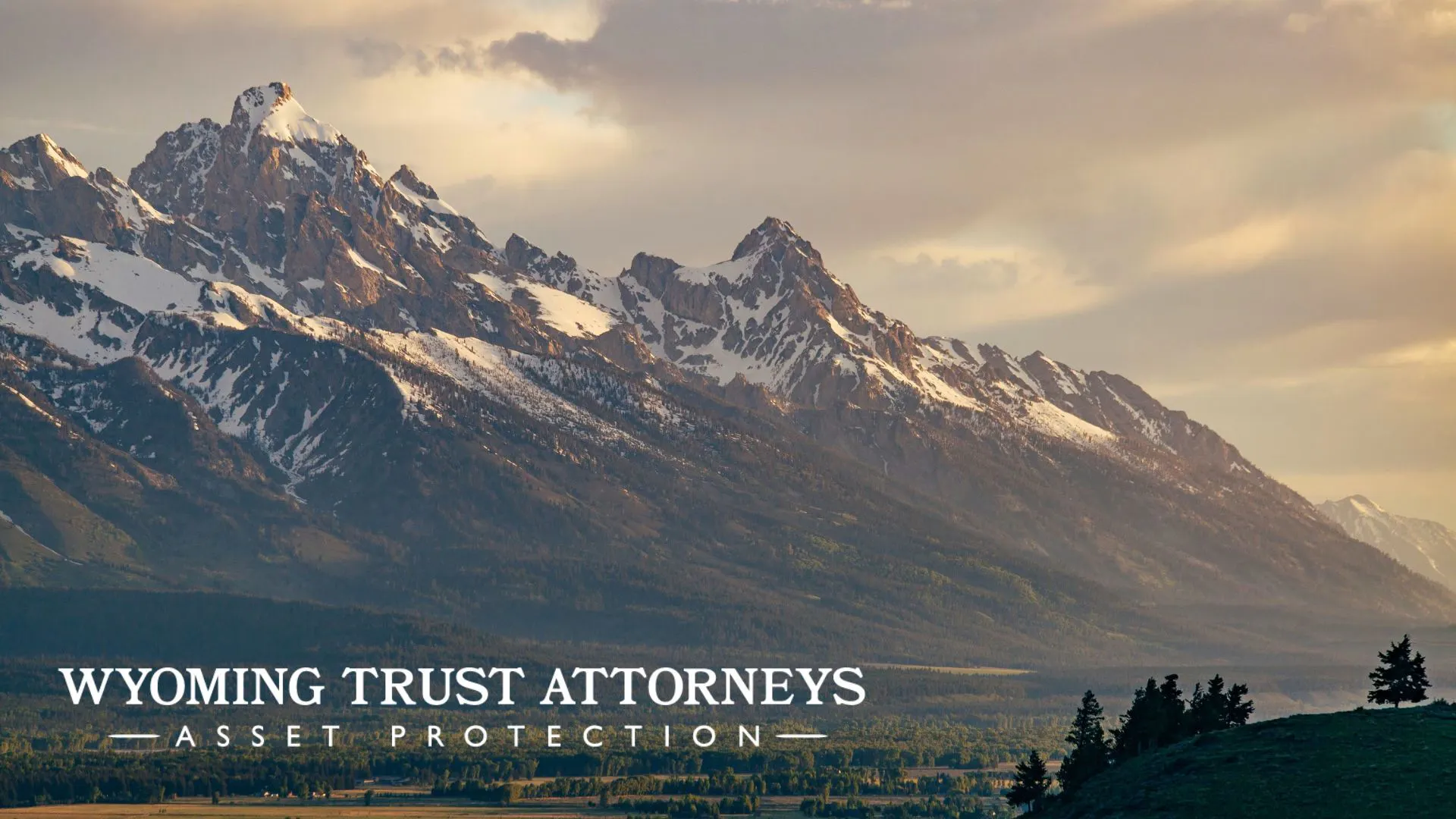 Image of Teton Moutains with Wyoming Trust Attorney Logo