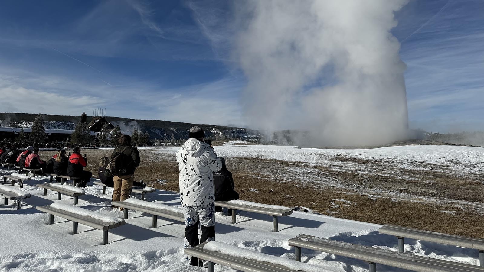 Visitors await a wintertime eruption of Old Faithful at Yellowstone National Park.