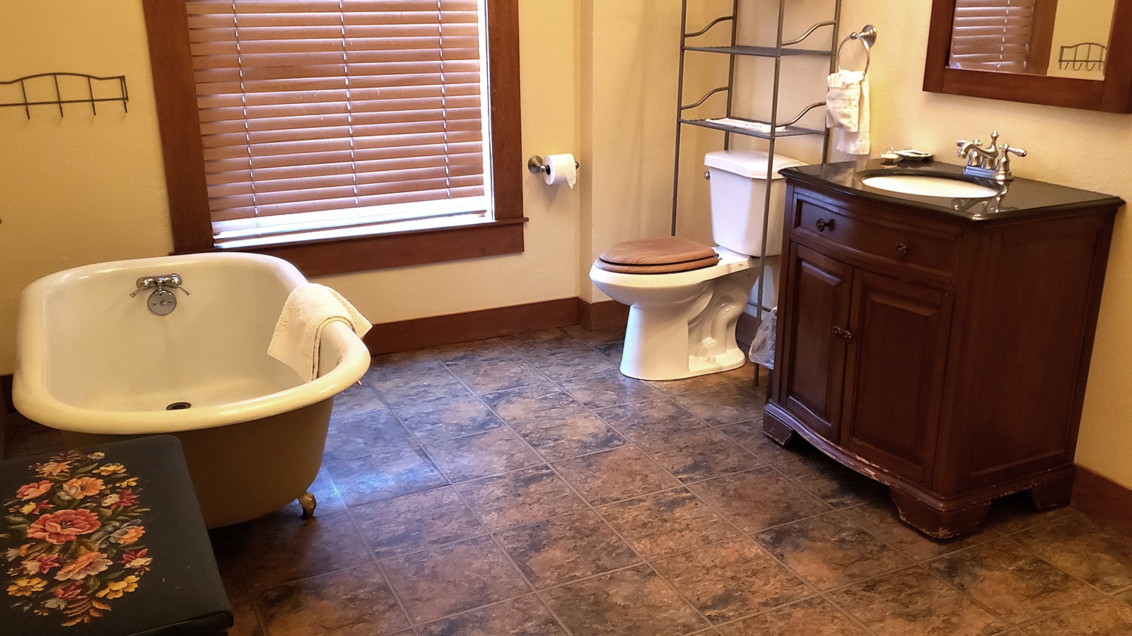 An old fashioned clawfoot tub awaits in a spacious bathroom in the Cloud Peak Suite.