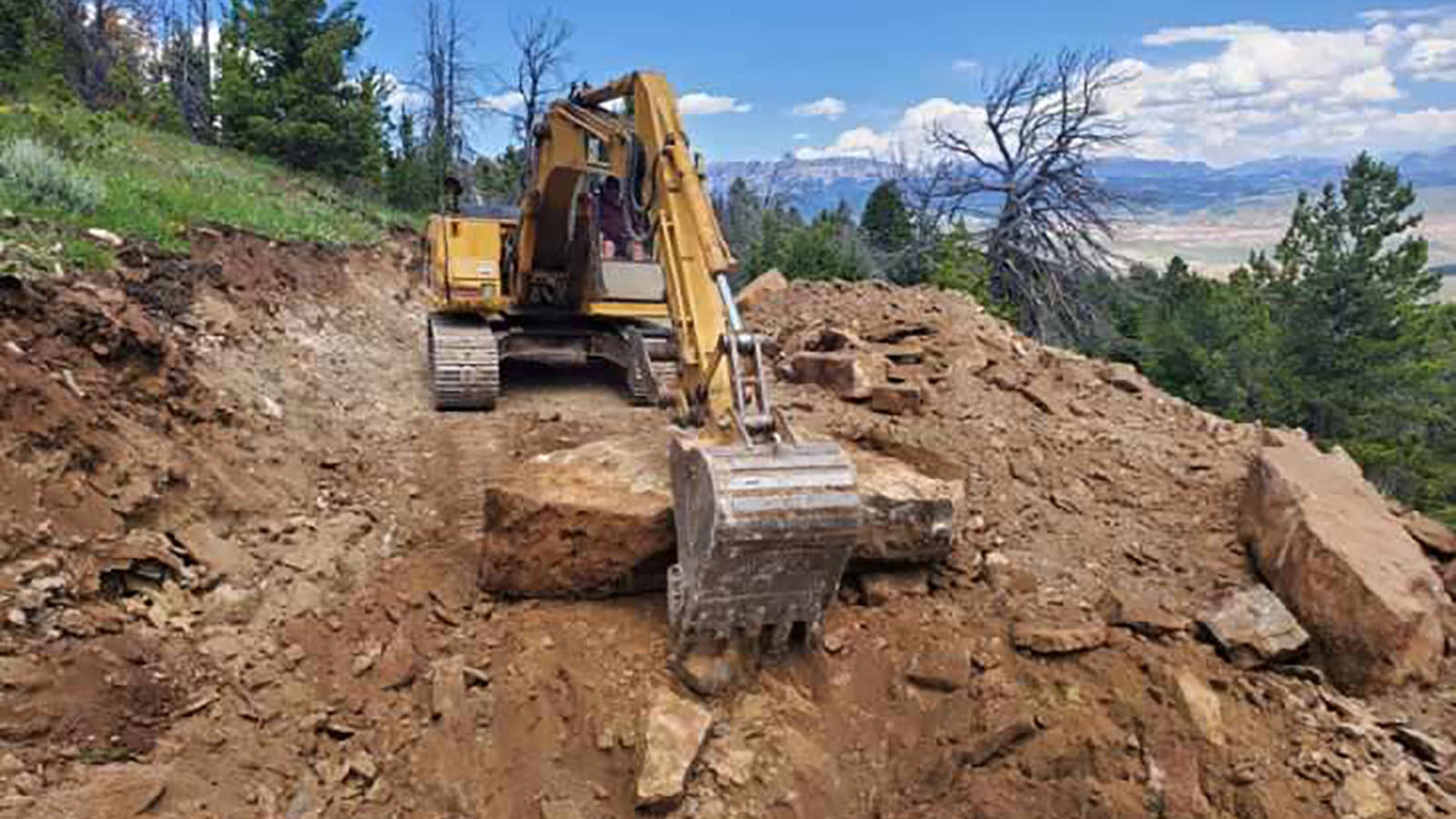 Septic tank installation underway at Cody Letteire’s off-grid mountain cabin near Dubois.