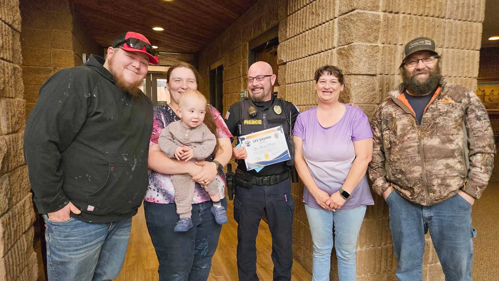 Glenrock Police Officer Shane Pierce with his neighbors celebrating a positive outcome for little Colton Trullinger. From left are Justin Trullinger, Autumn Trullinger, Colton, Shane Pierce, Kathryn Lenzen and Alvin Lenzen.