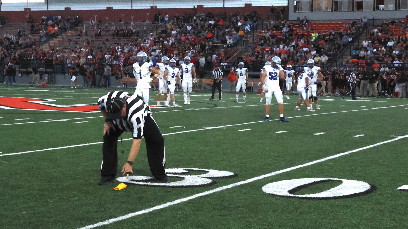 David Willems picks up a flag the threw during the Natrona County High School and Thunder Basin game.