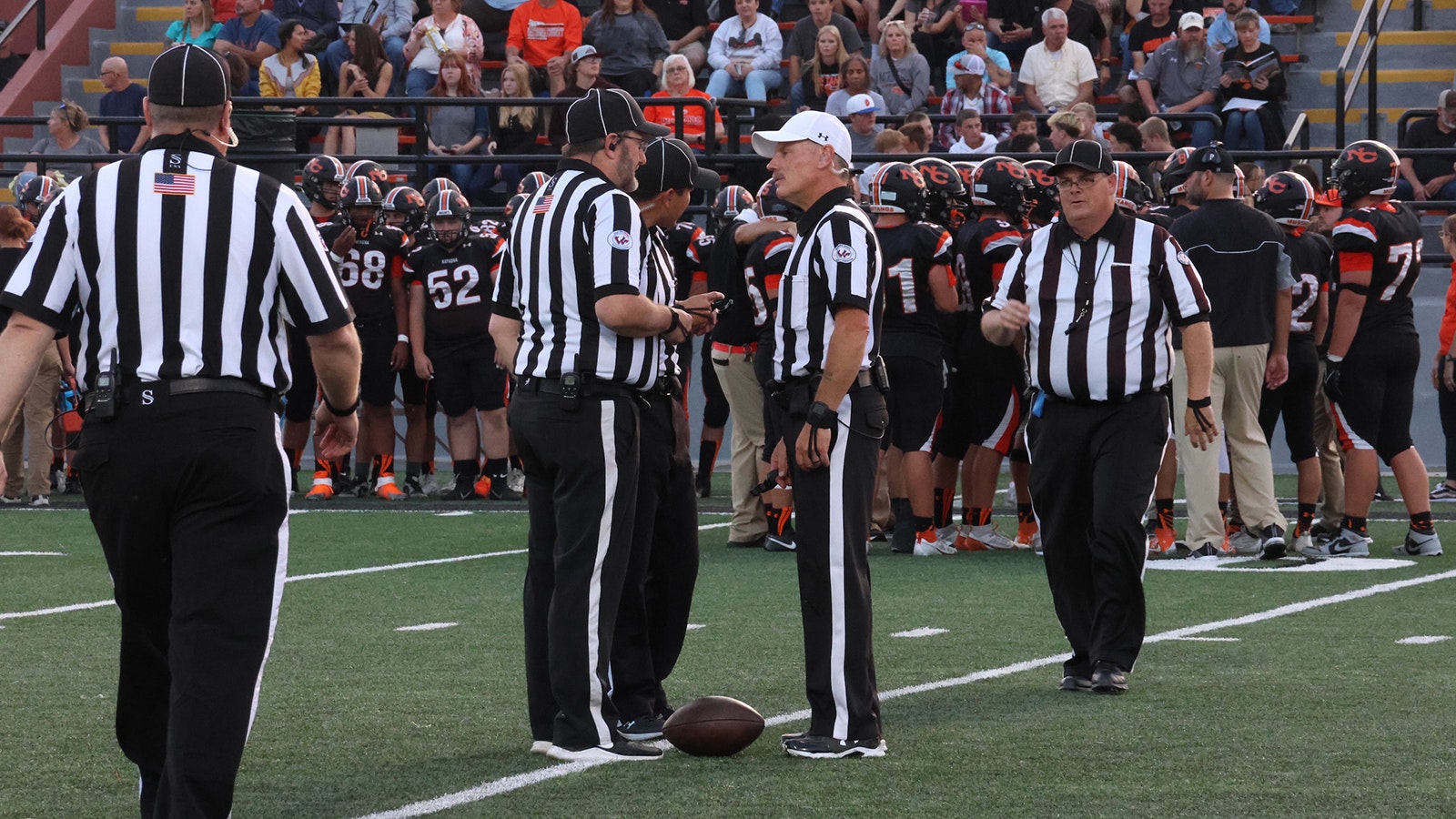 he officiating team comes together to confer during a timeout.