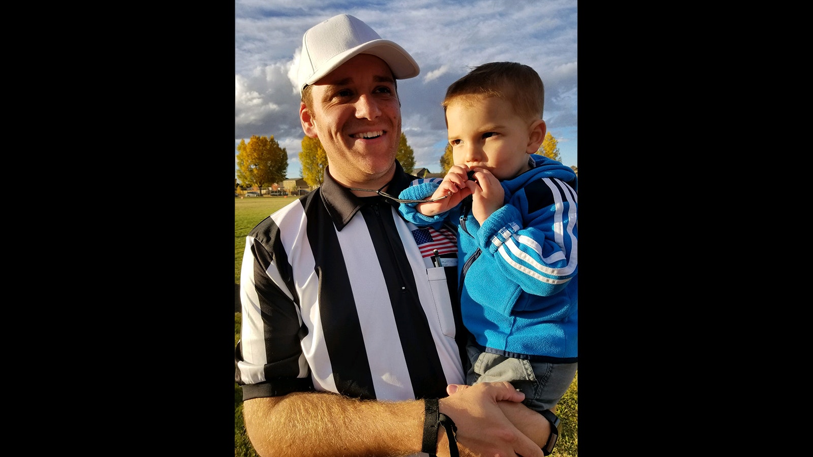 Laramie Football Officials President Tyler Spear has been officiating football games since he was a freshman in college. He also serves as state coordinator of football officials for the Wyoming High School Activities Association (WHSAA). Here he holds his son, Matthew.