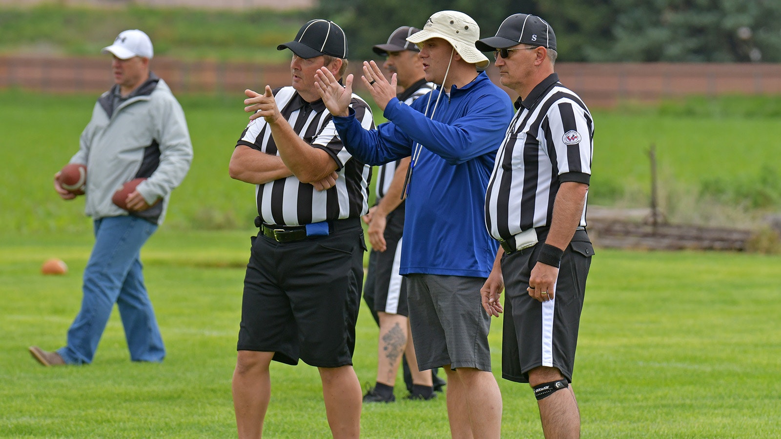 Tyler Spear, in blue shirt, helps provide instruction at a WHSAA football officials camp in Torrington in 2023.