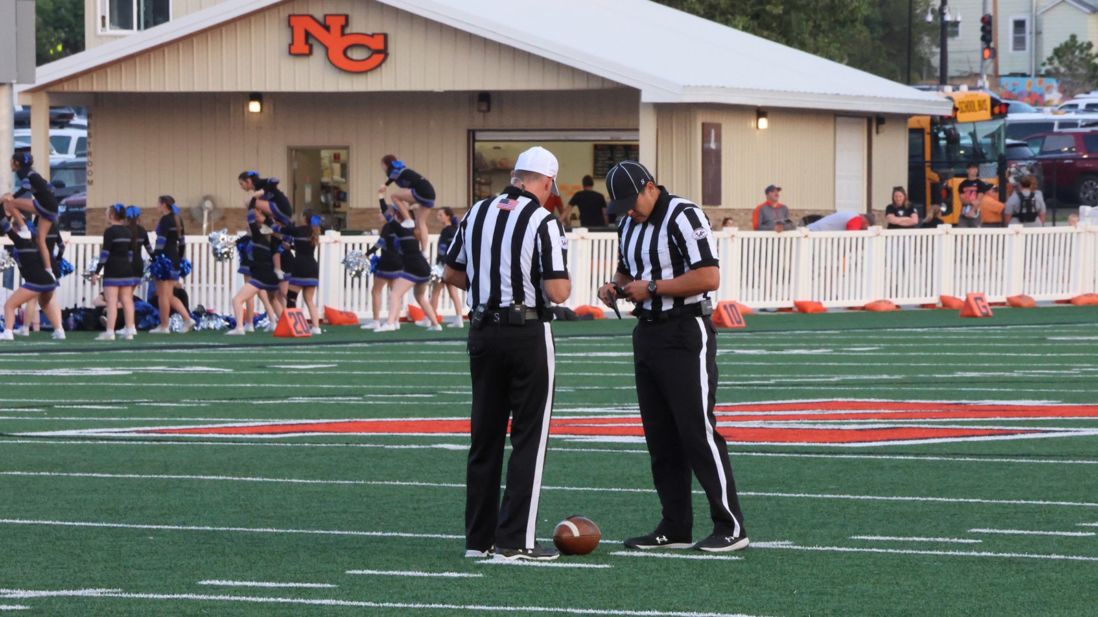 Referee Todd Pearson, left, and back judge Cameron Jaure check in with each other.