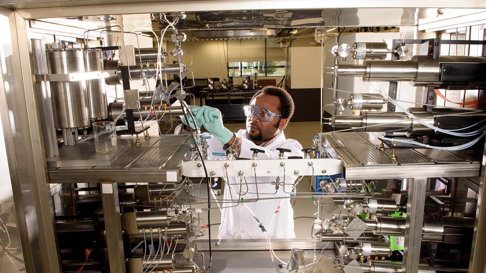 A researcher at the Center of Innovation for Flow Through Porous Media working at the University of Wyoming's High Bay Research Facility.