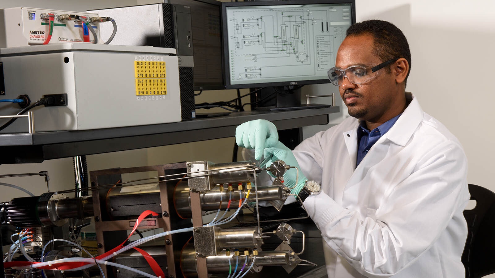 A researcher at the Center of Innovation for Flow Through Porous Media working at the University of Wyoming's High Bay Research Facility.