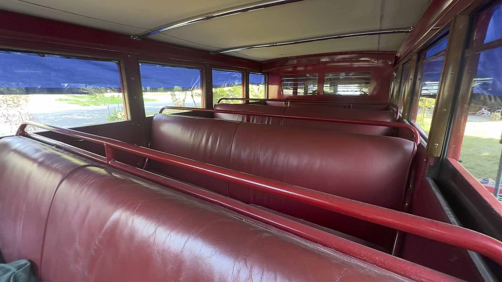 A relic on wheels, complete with a partial wood frame made of oak and red leather seats.