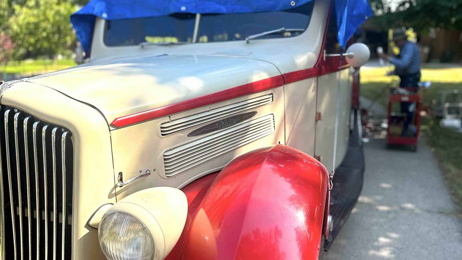 A relic on wheels, complete with a partial wood frame made of oak and red leather seats.