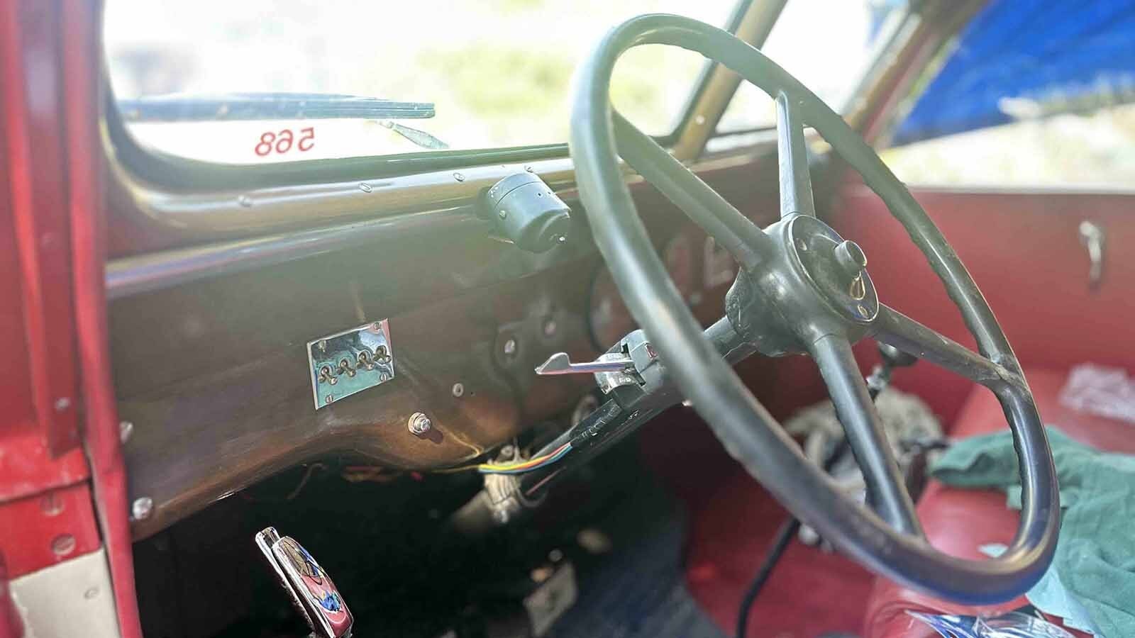 A relic on wheels, complete with a partial wood frame made of oak and red leather seats.