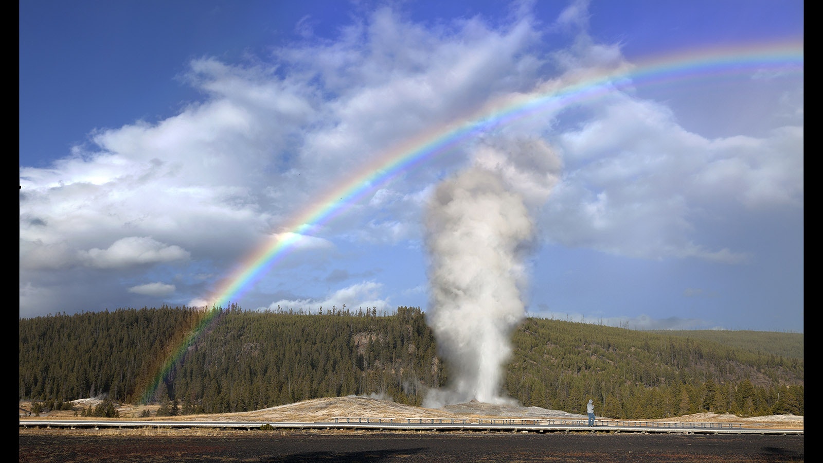 Old Faithful with a rainbow. While the most popular geyser in Yellowstone National Park, there are plenty of others work straying a little off the beaten path to see.