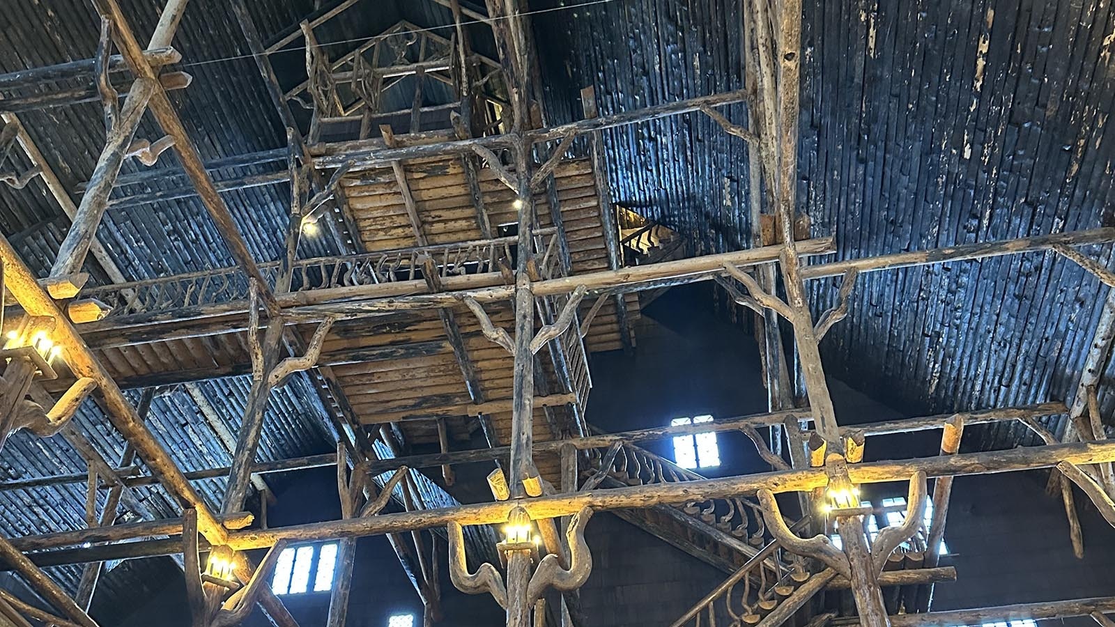 The crow’s nest towers overhead where the orchestra used to play to the crowds beneath at Old Faithful Inn in Yellowstone National Park.