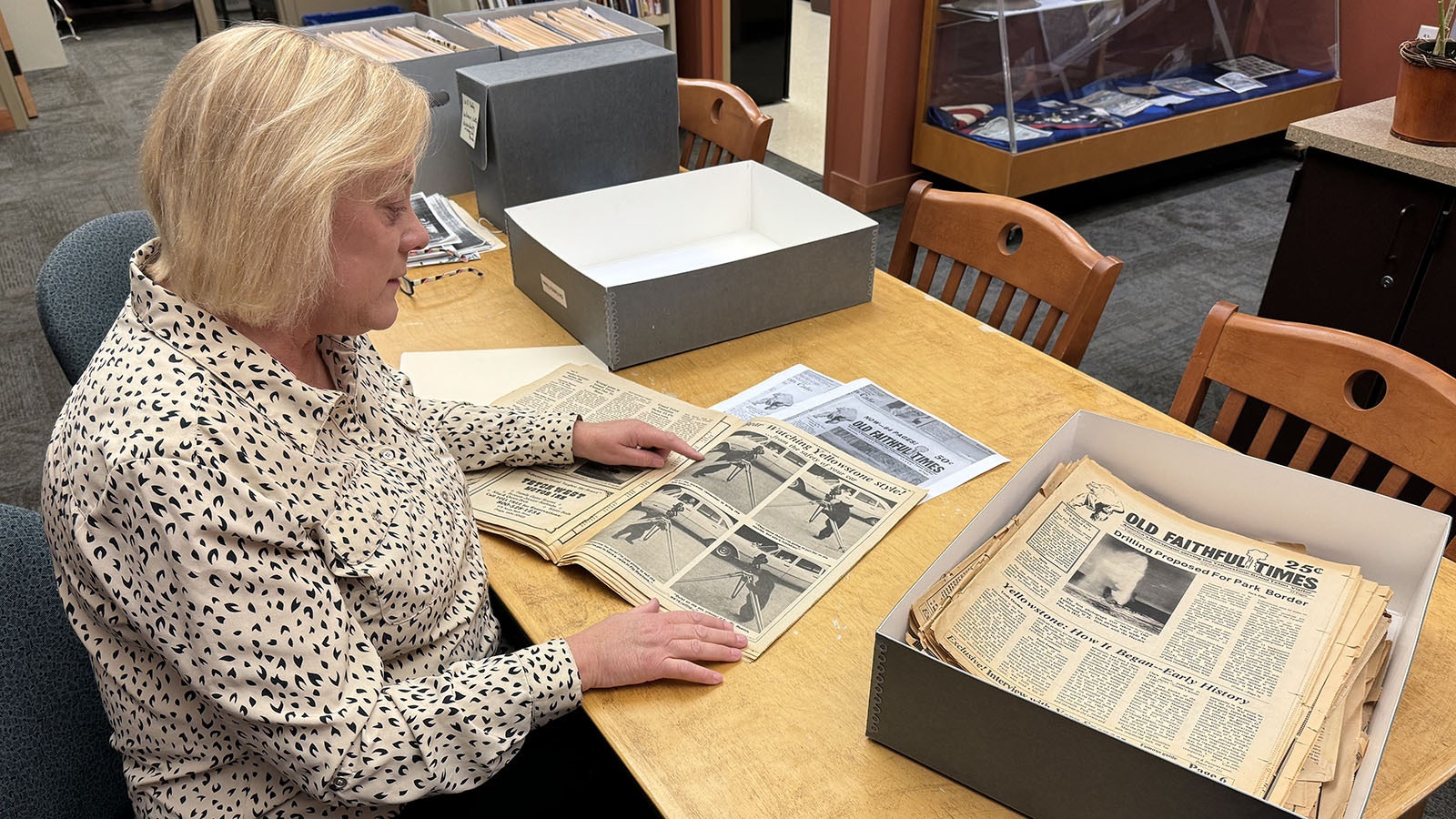 Park County Archivist Robyn Cutter studies an issue of the Old Faithful Times. She found the largest known collection of issues in the attic of her father-in-law Joe Cutter, the man who created and published the weekly newspaper in the 1970s.