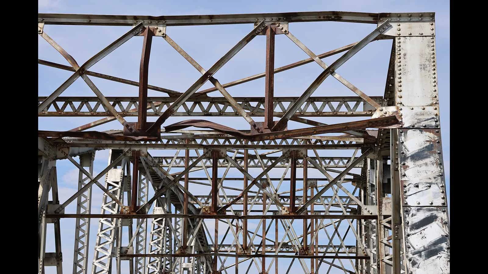 Bent and broken metal at the top of the bridge reveal a possible accident in its past.
