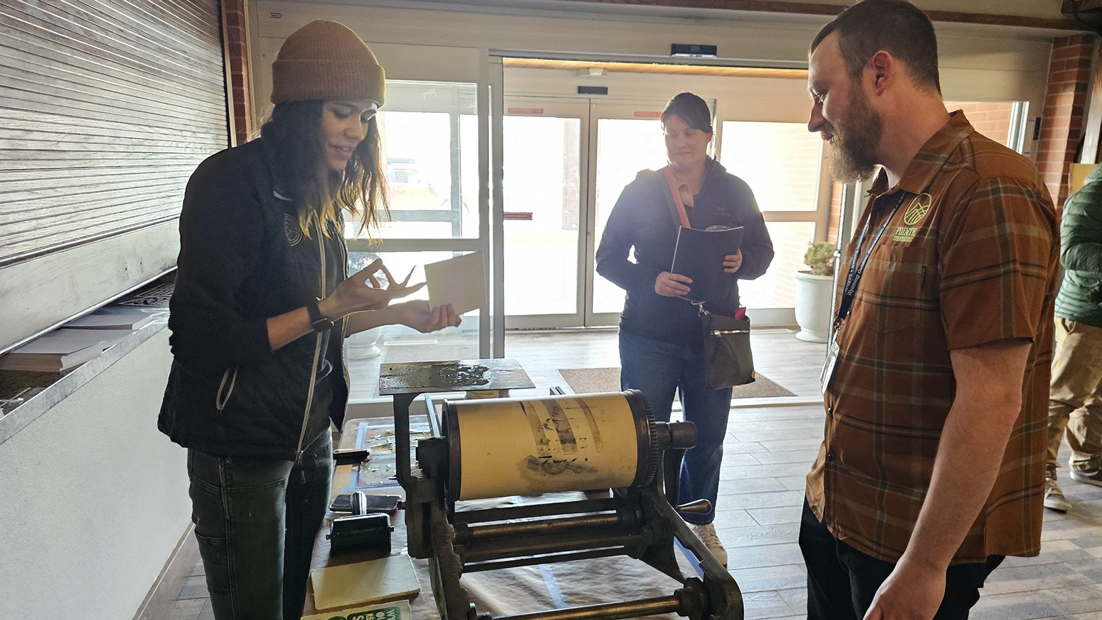 Kayla Clark explains how her 125-year-old printing press Poco works to a participant at the Worth Outdoor Tourism Summit in Casper. The press is something she picked up from a poet as a "portable" option for events. It weighs 250 pounds.