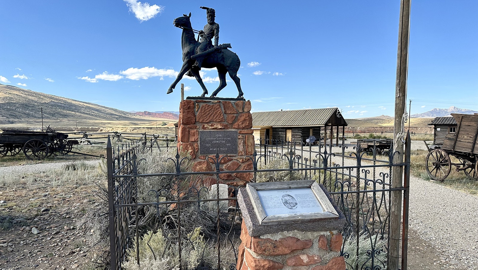 The grave of Jeremiah "Liver Eating" Johnson at Old Trail Town. Johnson's remains were exhumed in California and reburied in Cody in 1974. His funeral attracted over 2,000 people, including actor Robert Redford, making it one of the largest in state history.