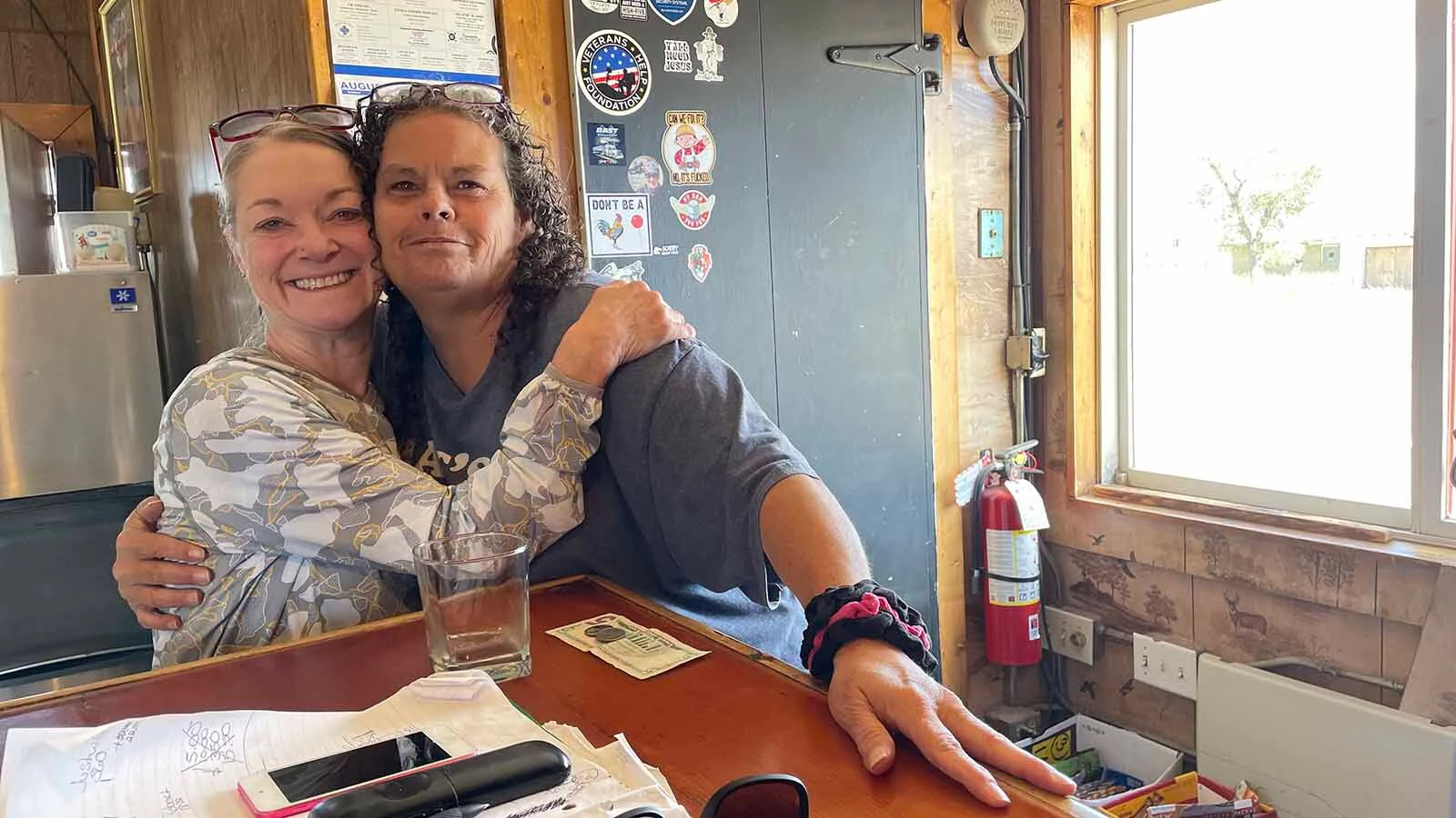 Old West Bar owner Kristi Wickizer, right, catches up with an old friend.