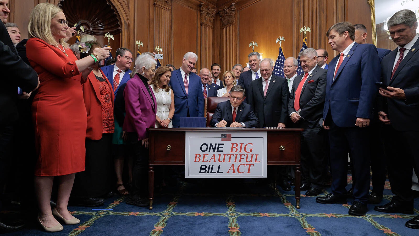 U.S. House Speaker Mike Johnson signs the massive budget bill known as the One Big Beautiful Bill after it passed the House on Thursday, July 3, 2024.