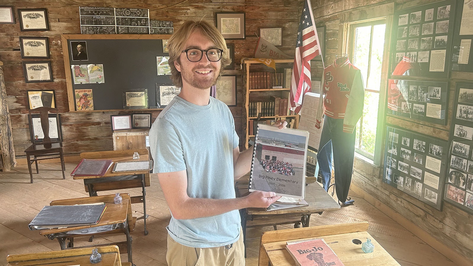Buck Bell shows his Big Piney Elementary Yearbook from 2005. Bell is assistant manager at the Green River Valley Museum and the yearbook is on display inside the Price / Sommers Schoolhouse, an exhibit at the museum.