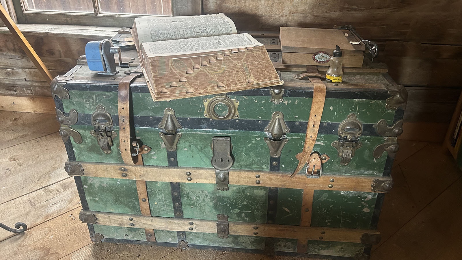 Education’s tools on display at the Price/Sommers Schoolhouse. This photo shows a trunk with a pencil sharpener, paper cutter and large dictionary.