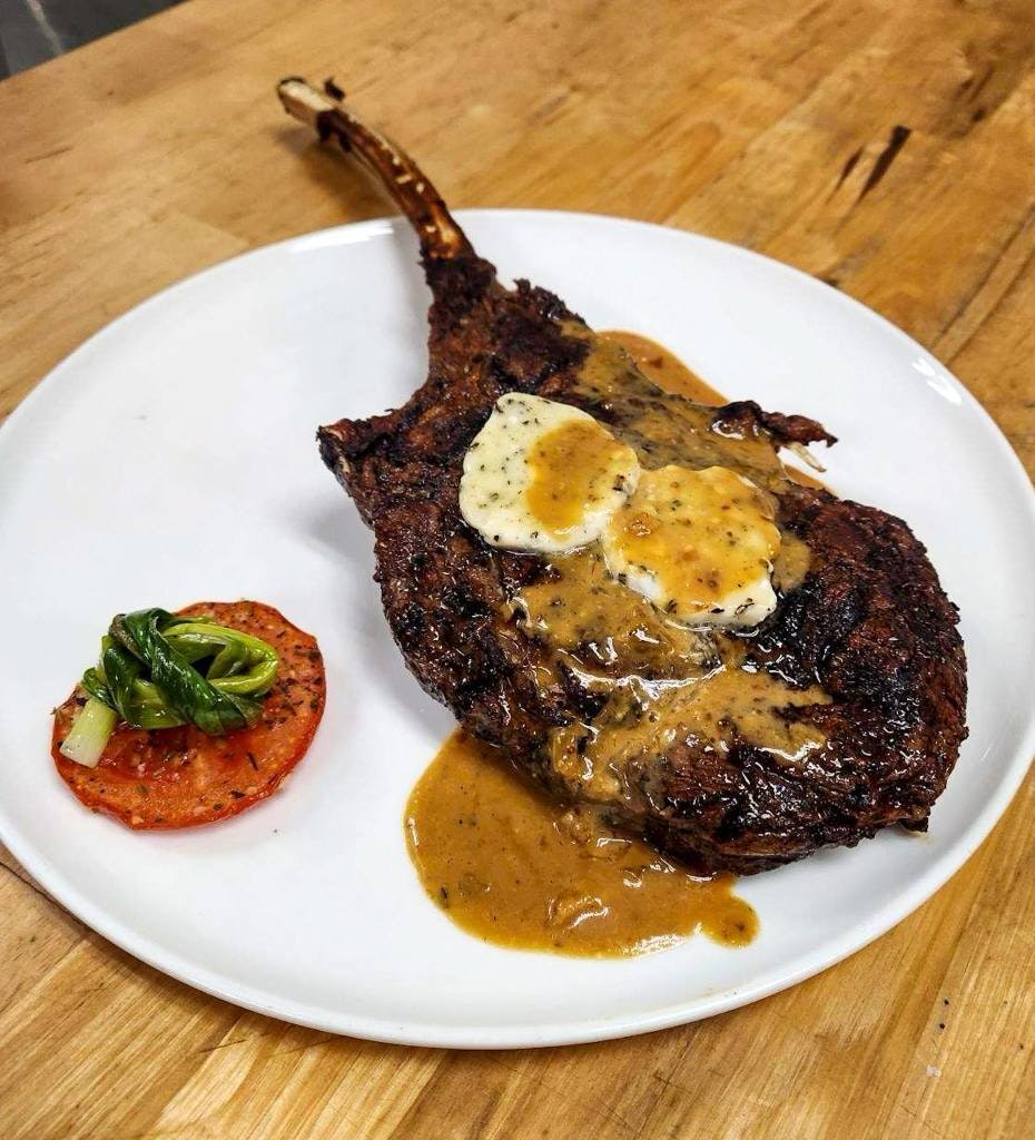 Bison tomahawk steak with gorgonzola butter.