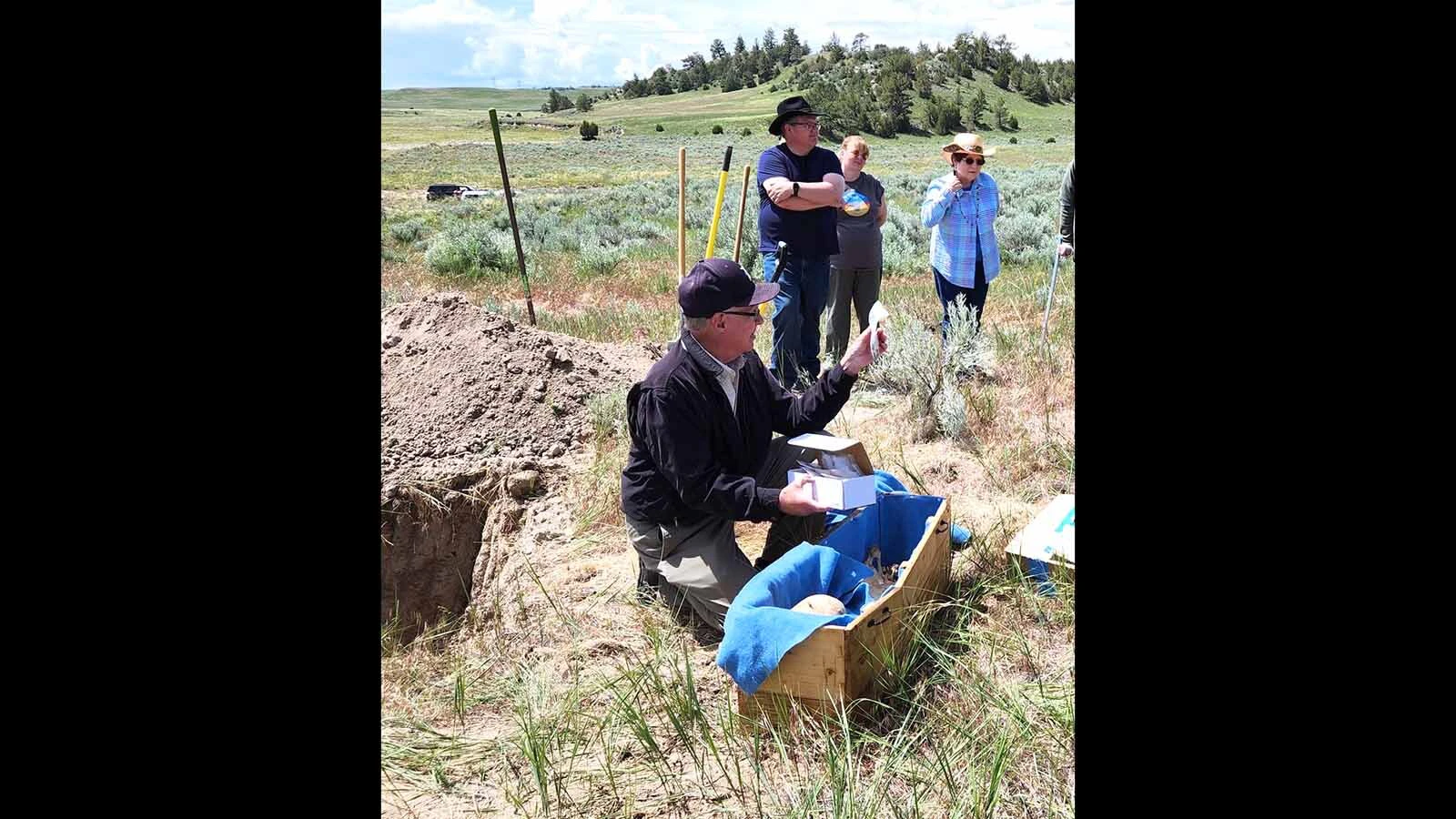 Randy Brown works at a pioneer grave site along the Oregon Trail in Wyoming.
