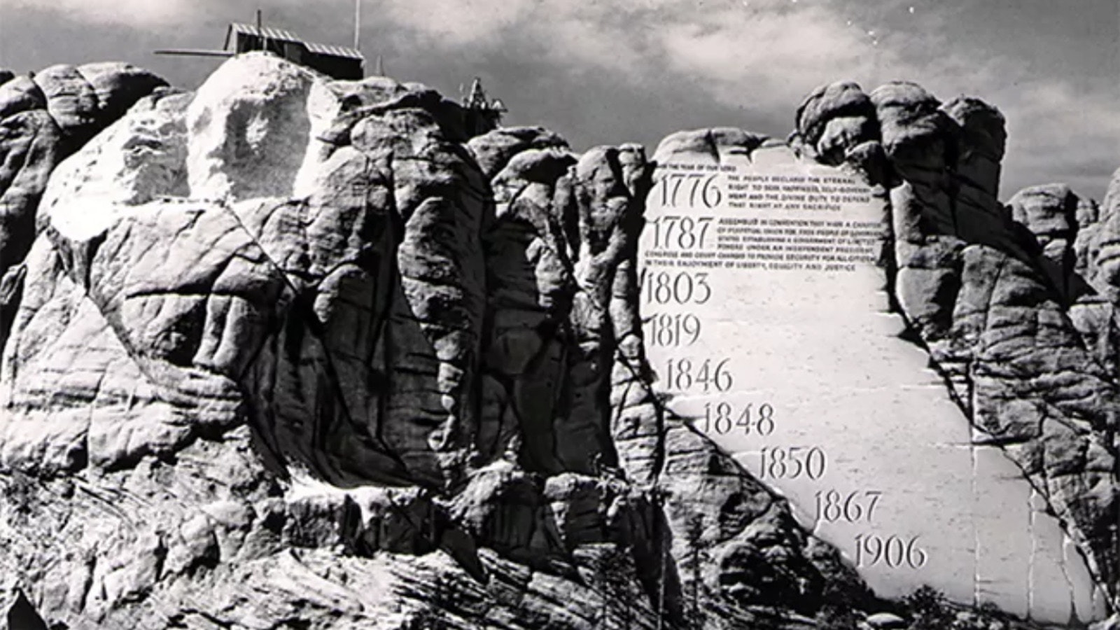 Mount Rushmore as carving began. The Entablature is seen on the right as a conceptual drawing added to the photo.