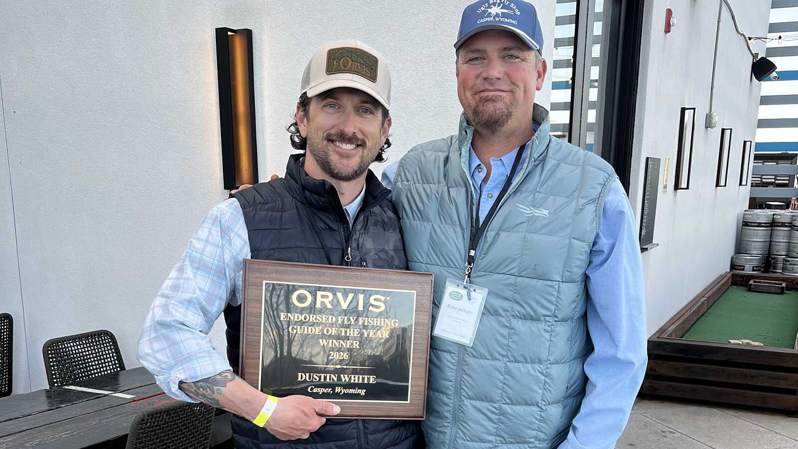 Fly-fishing guide Dustin White, left, and Ugly Bug Fly Shop owner Blake Jackson show off White’s Orvis Fly Fishing Guide of the Year Award.