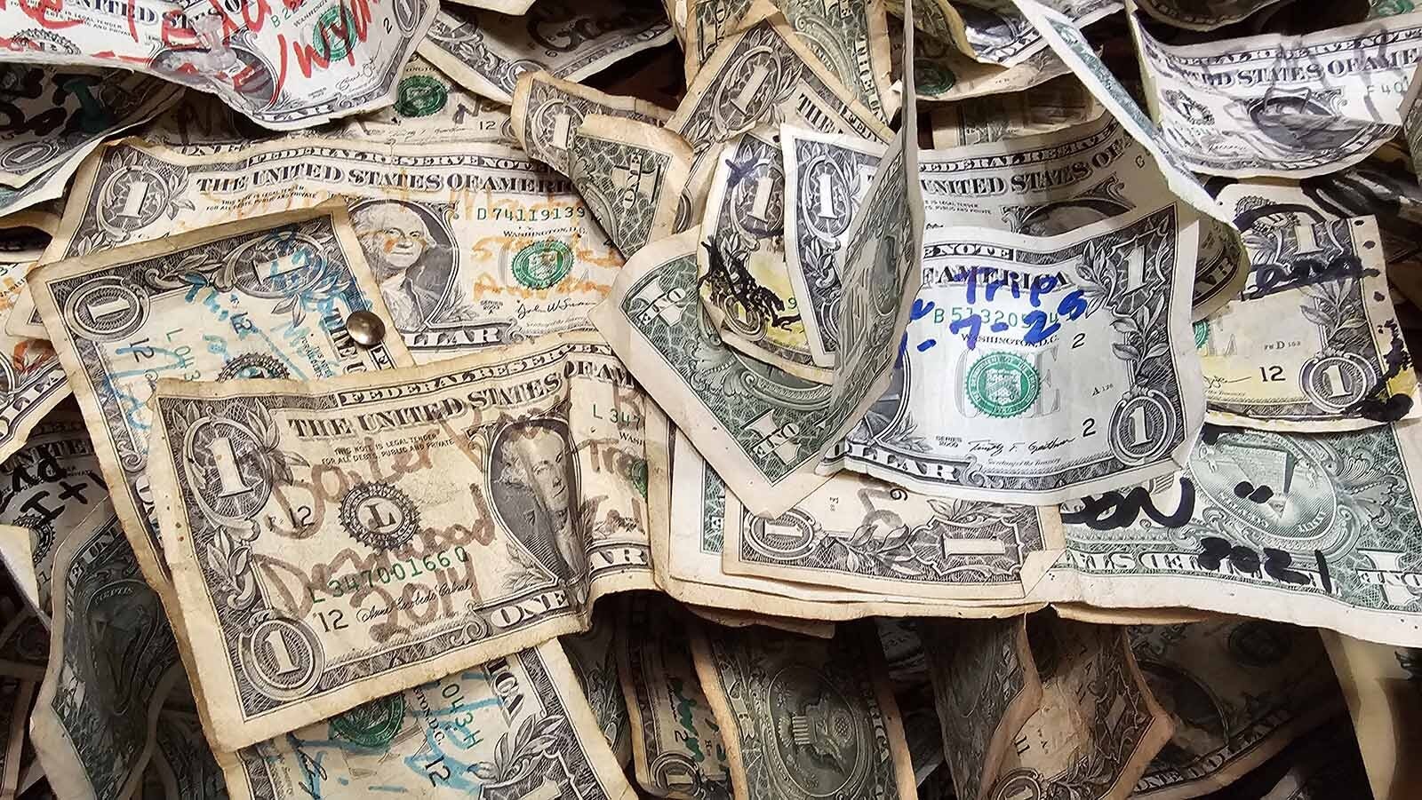 Most of the dollars pinned to The Buckhorn Bar's walls and ceiling have messages written on them. The bar is the last oasis of civilization for a while as people leave Wyoming, headed to Deadwood on Highway 85.