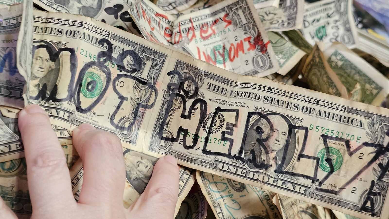 A bill pined to The Buckhorn Bar's walls with a 2020 message on it.