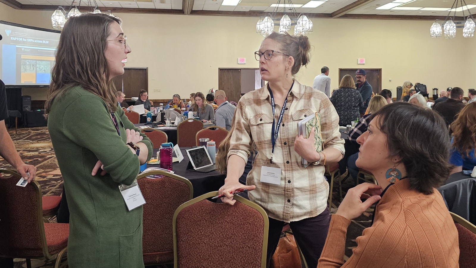 Annie Robins, center, talks with SE Group Associate Planner Lindsey Romaniello, right, and environmental planner and analyst Catherine Winnop during the Outdoor Recreation Summit in Casper this week.