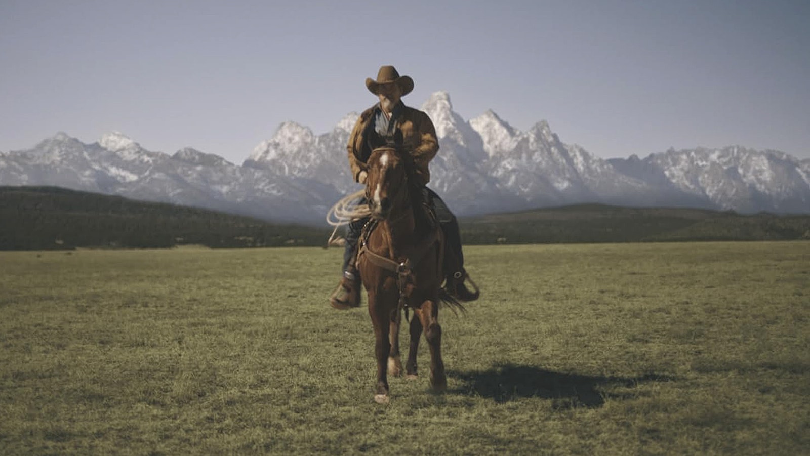 Rancher Royal Abbott rides his range in New Mexico with CGI Tetons serving to place his spread in Wyoming.